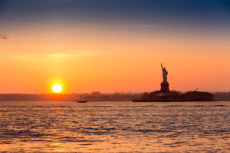 40299973 - statue of liberty at sunset as viewed from brooklyn new york