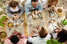 44666558 - group of young friends gathered at thanksgiving dinner table