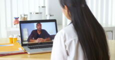 33806243 - chinese doctor video chatting with african patient