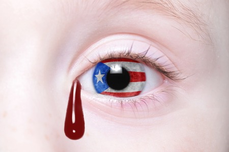 54395564 - human's eye with national flag of puerto rico with bloody tears