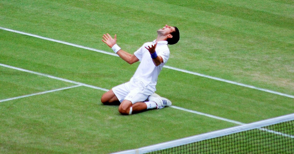 Novak Djokovic on his knees celebrating